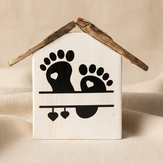 Rohling des personalisierten Geburtshäuschens aus Holz mit schwarzen Baby Fußabdrücken, Treibholz Dach und Geburtsdaten