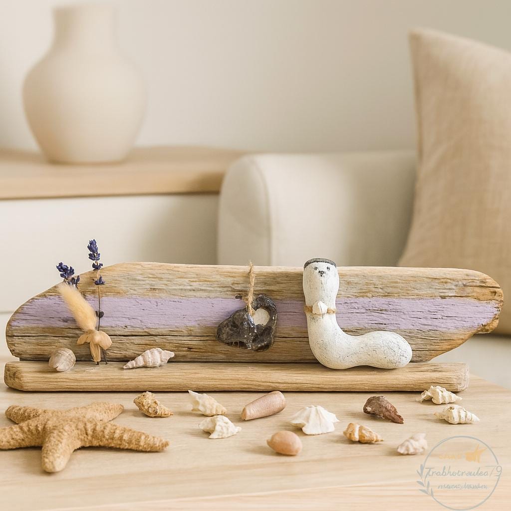 Maritime Treibholz Deko mit kleiner Steinfigur und Muscheln, liebevoll arrangiert auf Treibholz vor einer gemütlichen Couch.