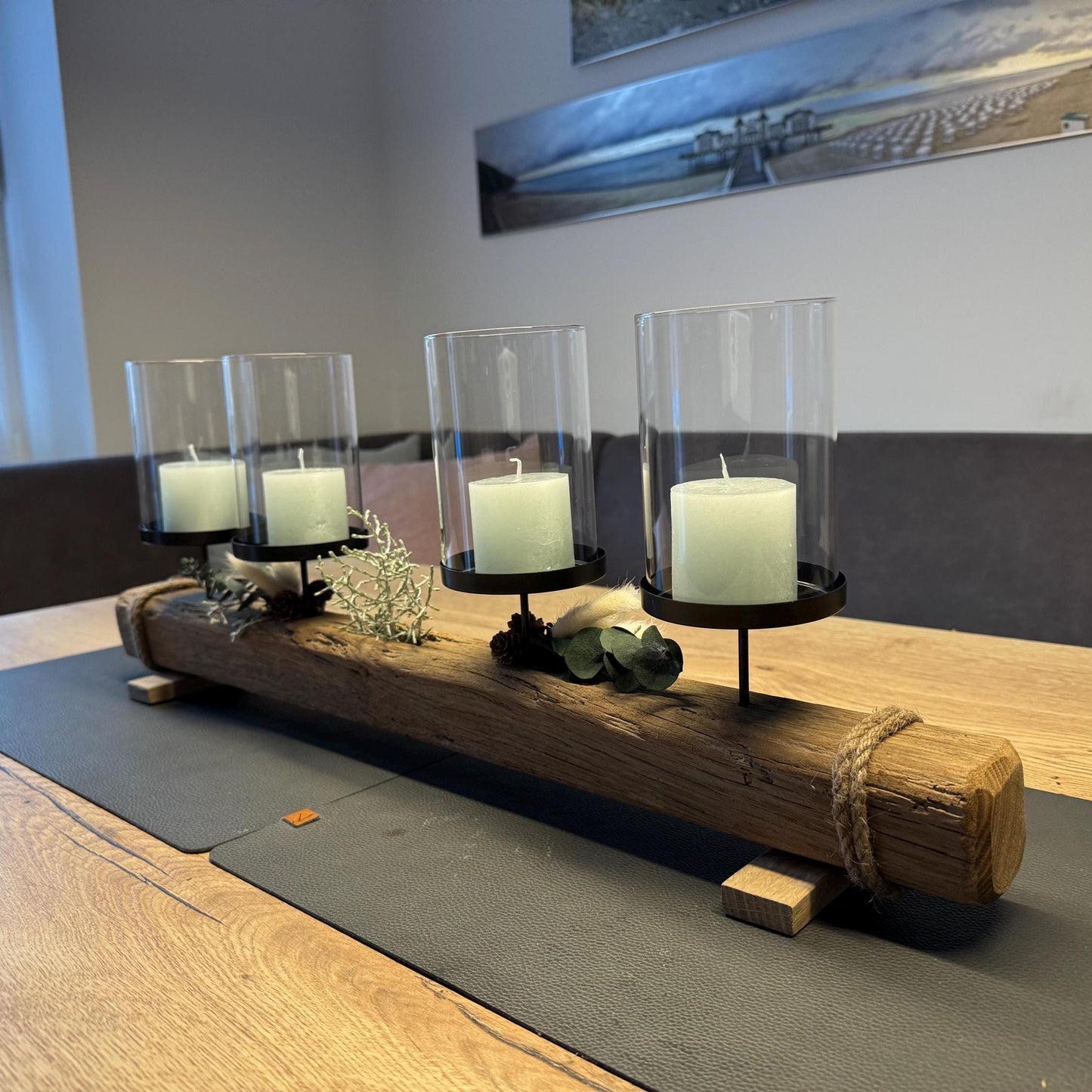 Weihnachtlicher Treibholz Kerzenhalter mit vier brennenden Kerzen und Glaszylinder im skandinavischen Weihnachtsambiente.